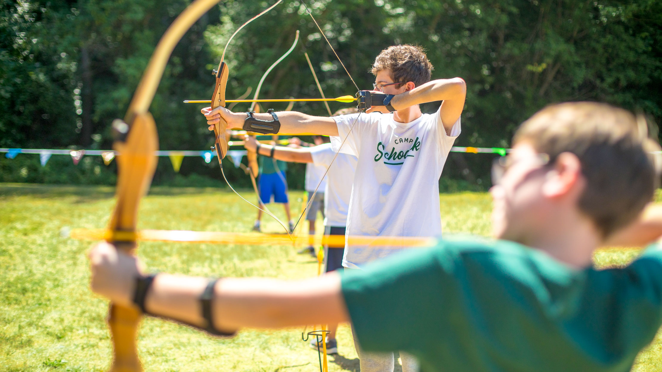 Boys doing archery at summer camp