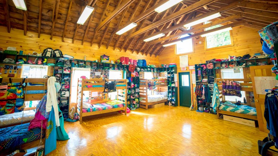 Interior view of Camp Schodack's cabin bunks, with camper decorations