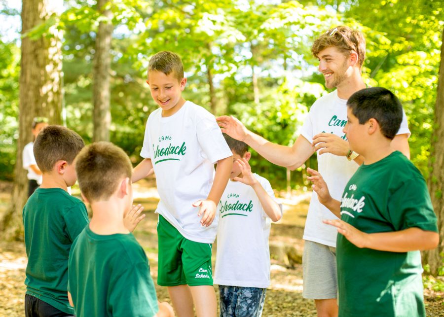 Group of campers support each other on ropes course