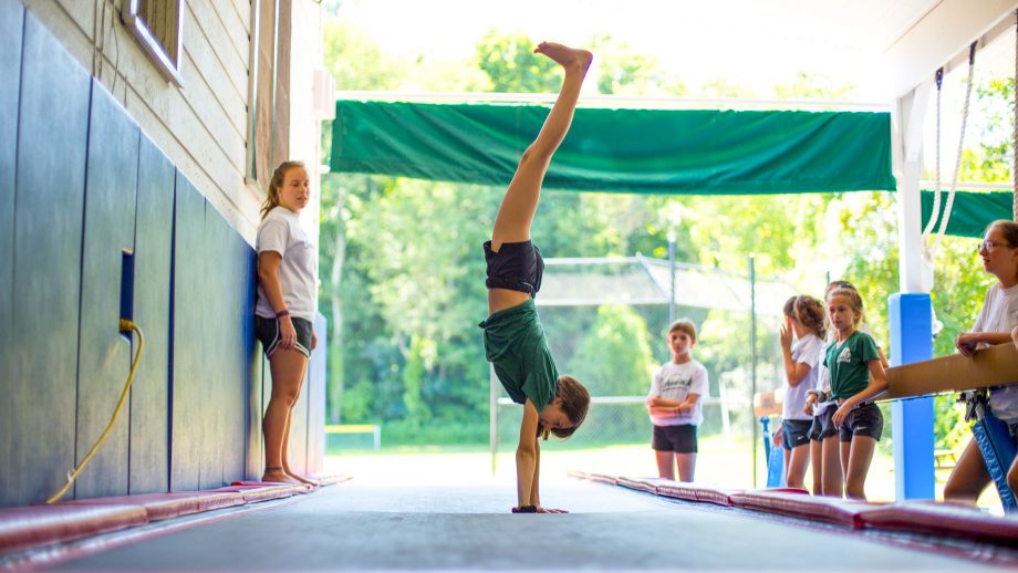 Camper does handstand during gymnastics