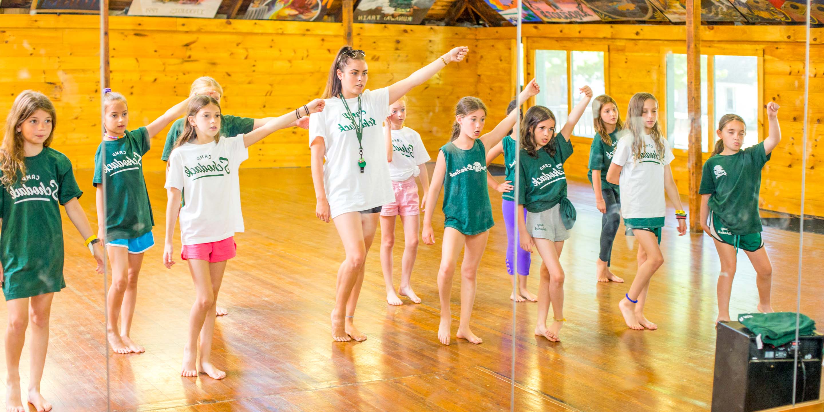 Group dance in front of camp studio mirrors