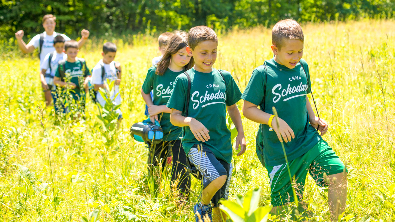 Group of young campers goes for a day hike