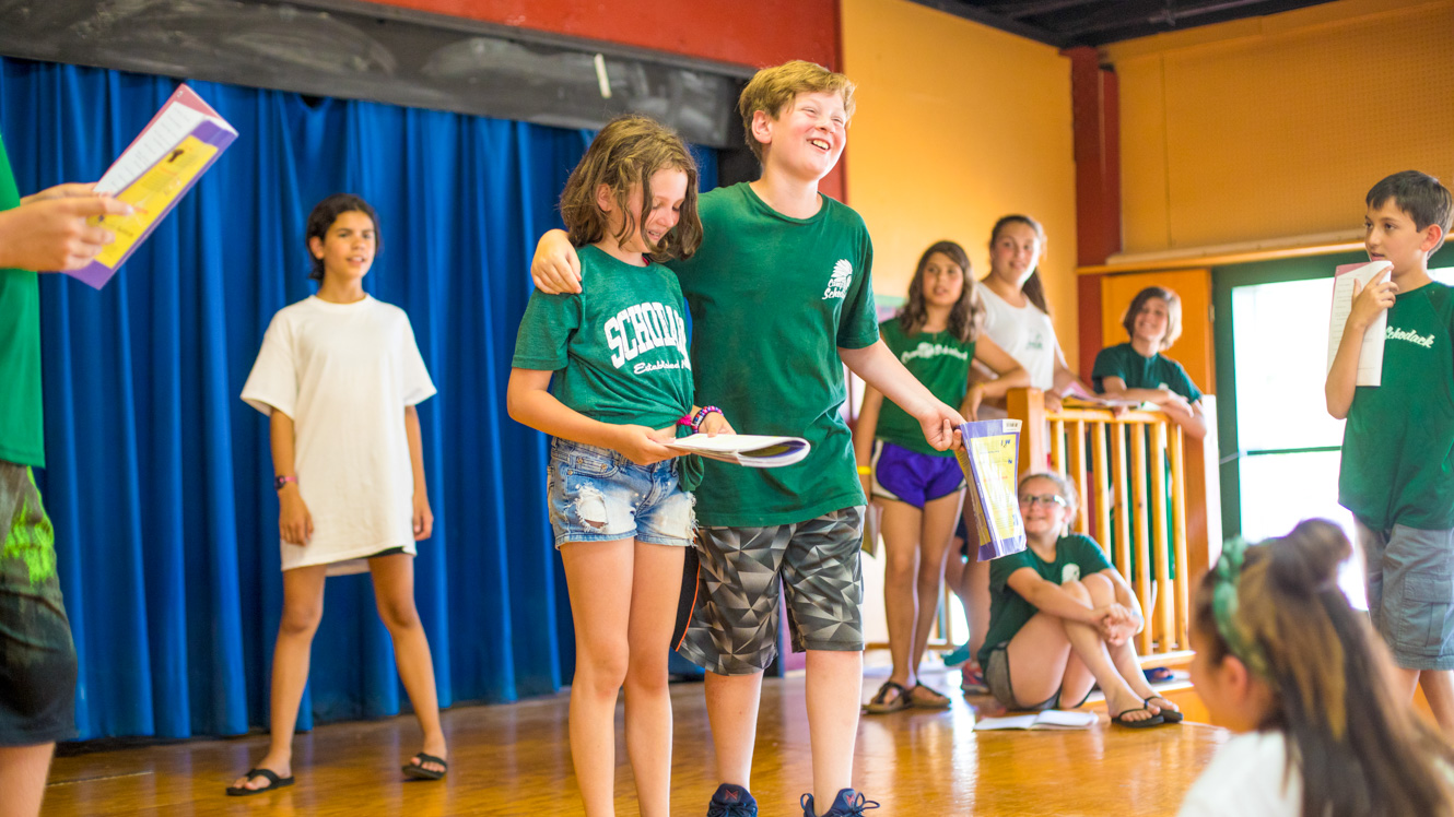 Group of campers perform on stage