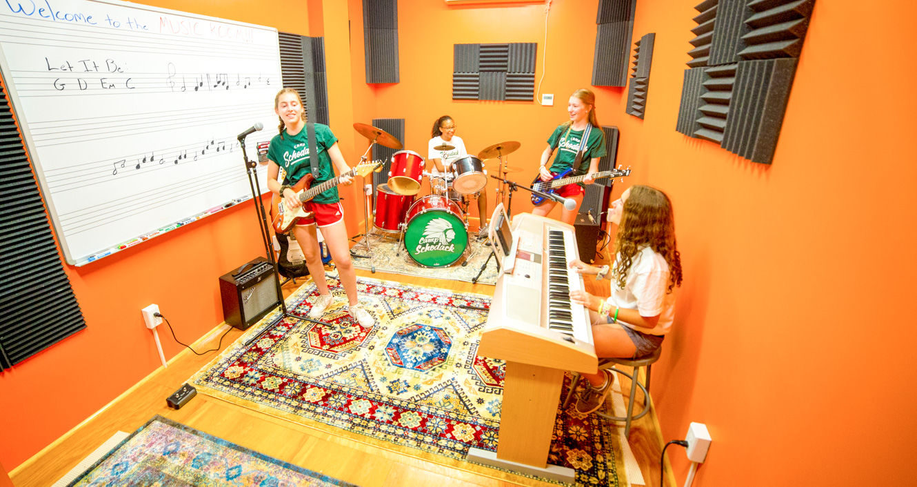 Girls practice music at summer camp