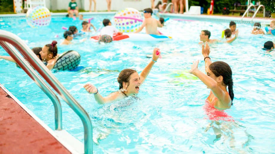 Girls have a pool party at summer camp