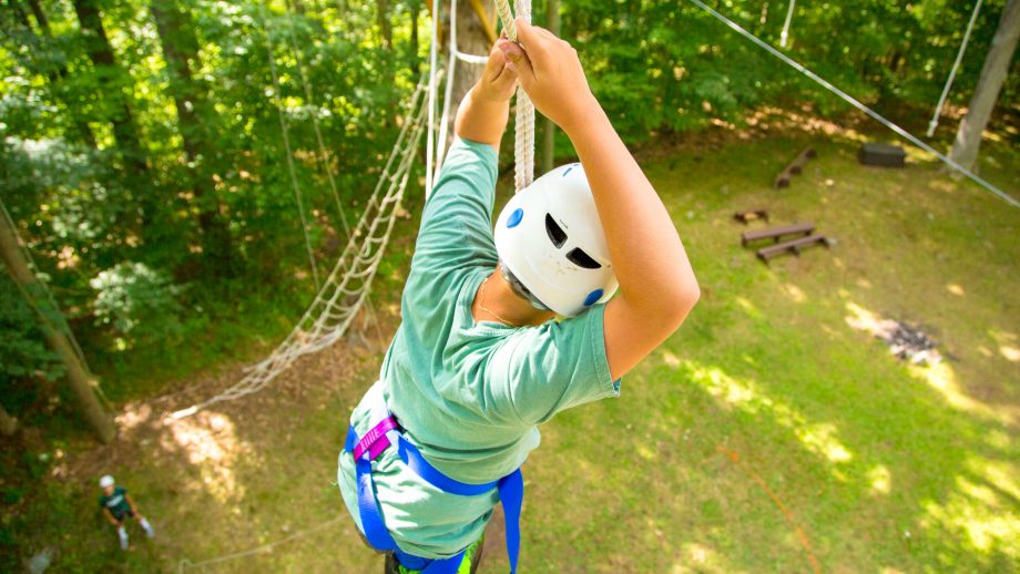 View from above as camper crosses high ropes course