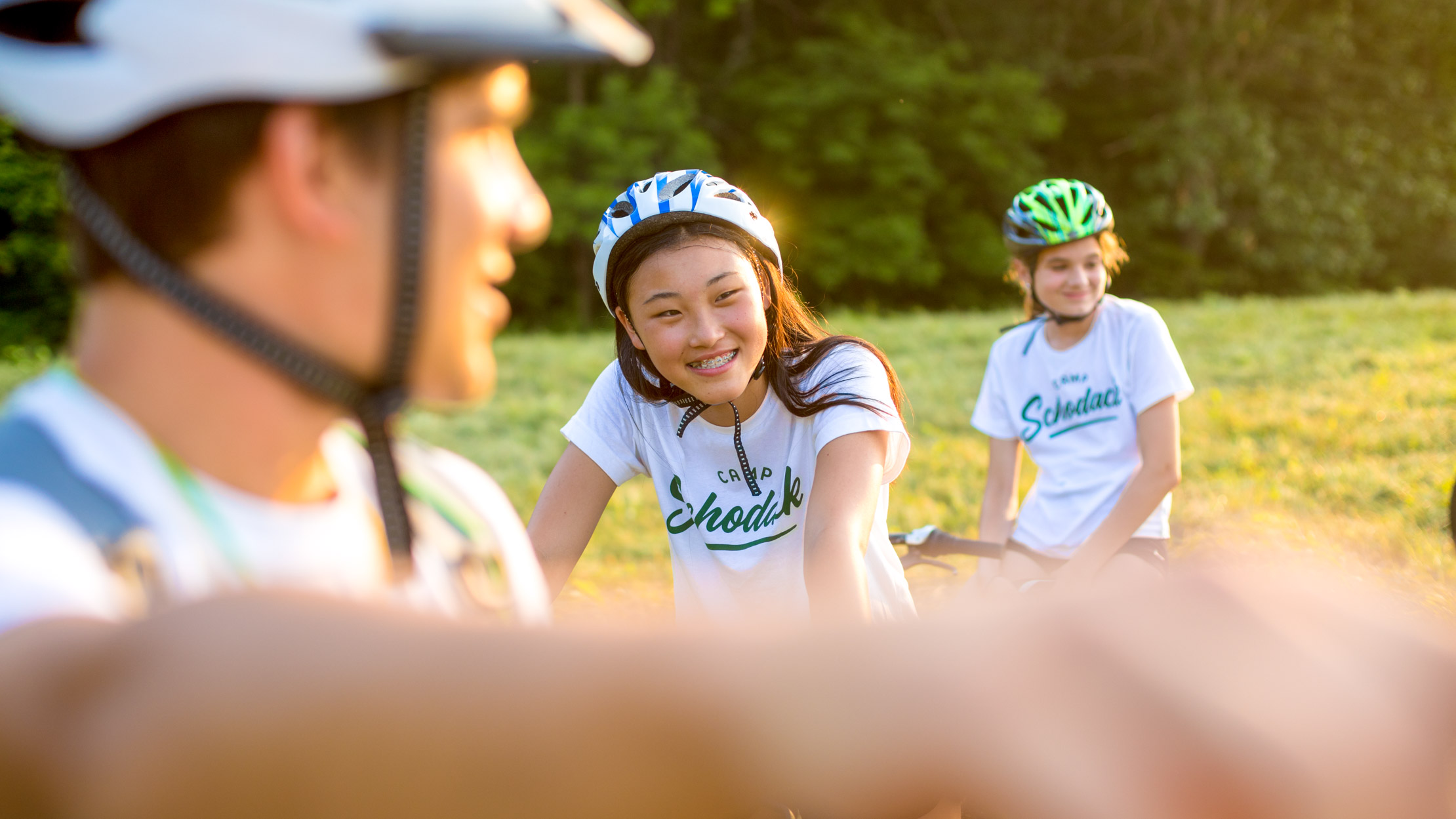 Girl smiles while mountain biking at summer camp