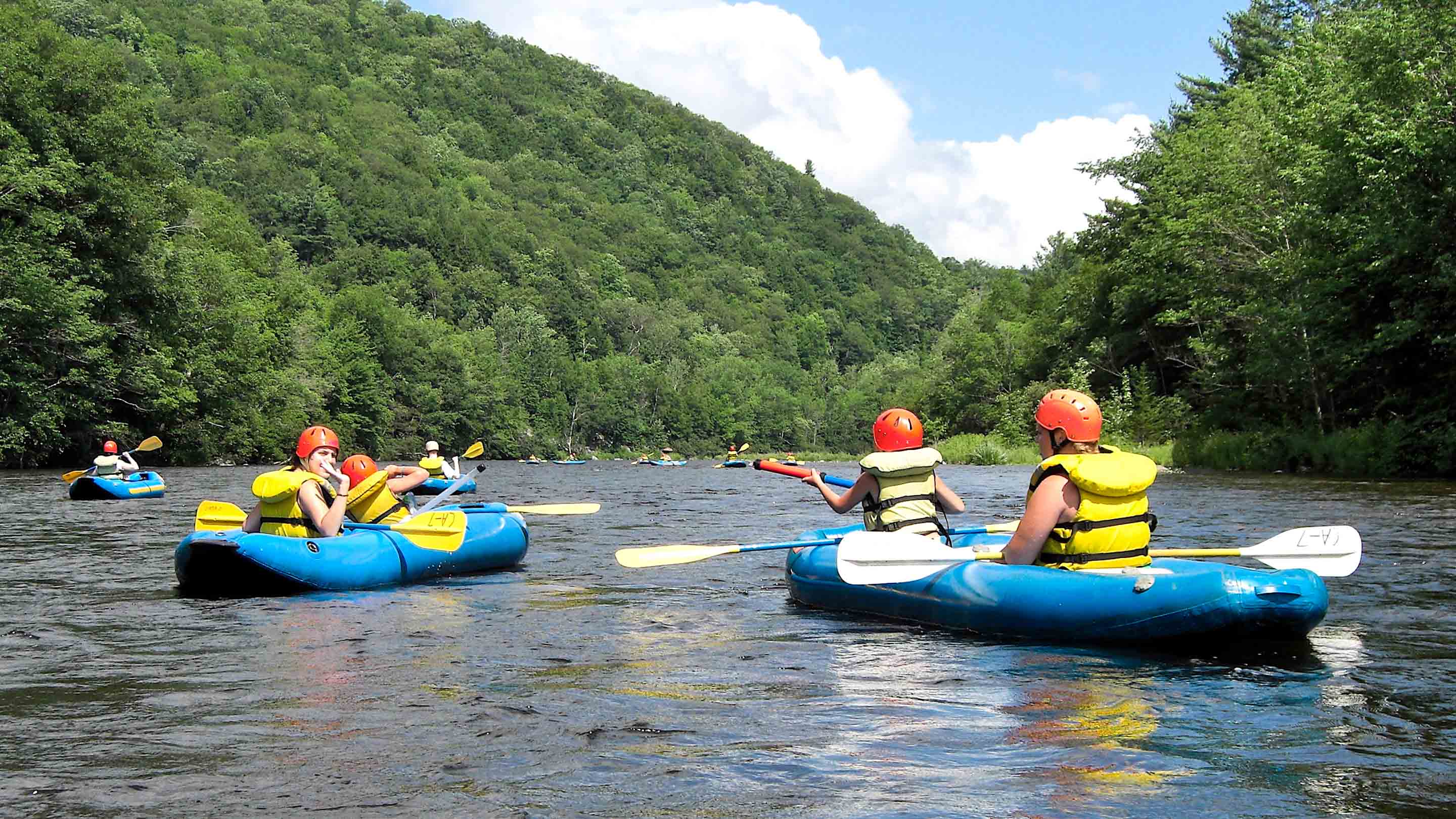 Campers kayaking on rafting trip