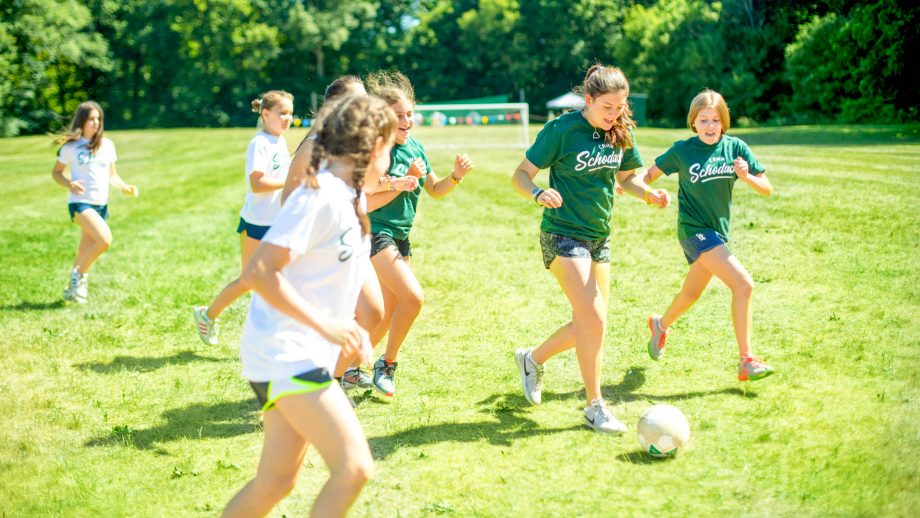 Girls play soccer at summer camp