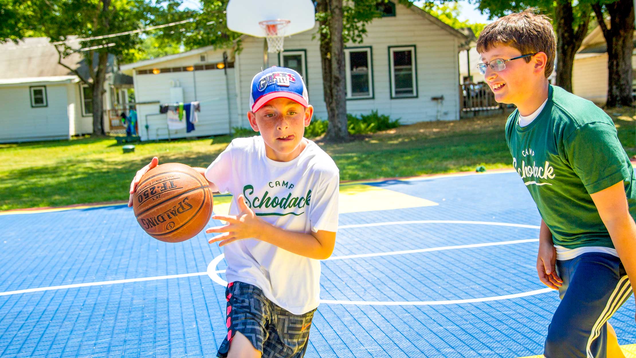 Camper dribbling ball across court