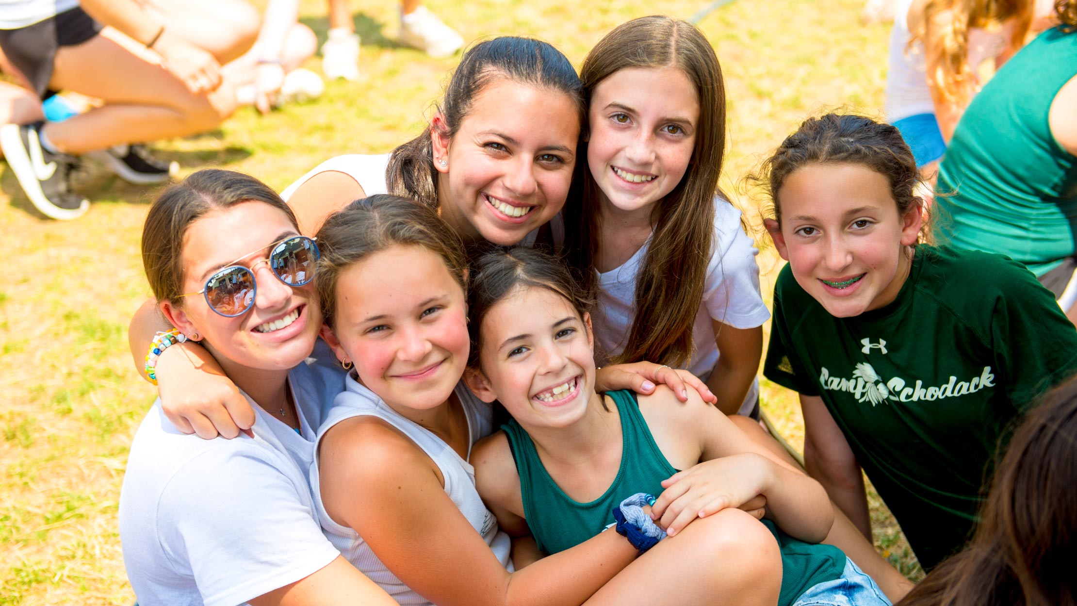 Campers and counselor group hug at summer camp