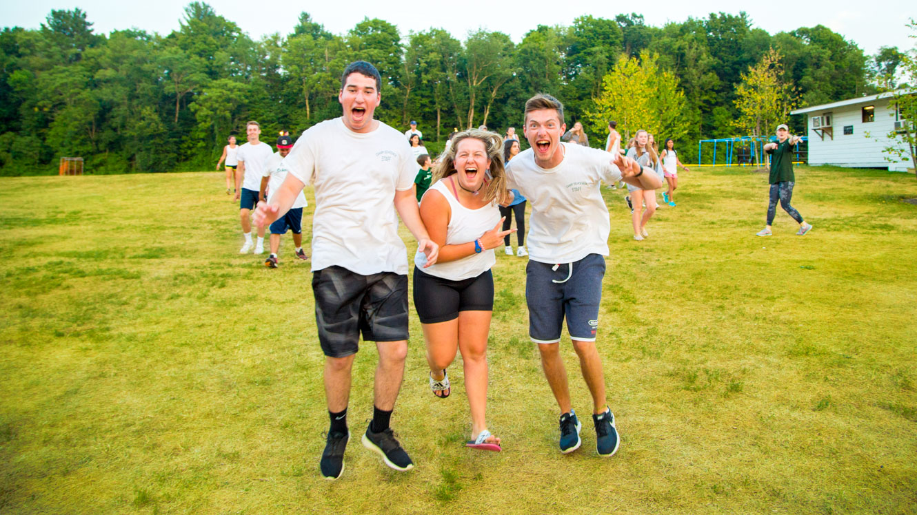 Staff members running across field